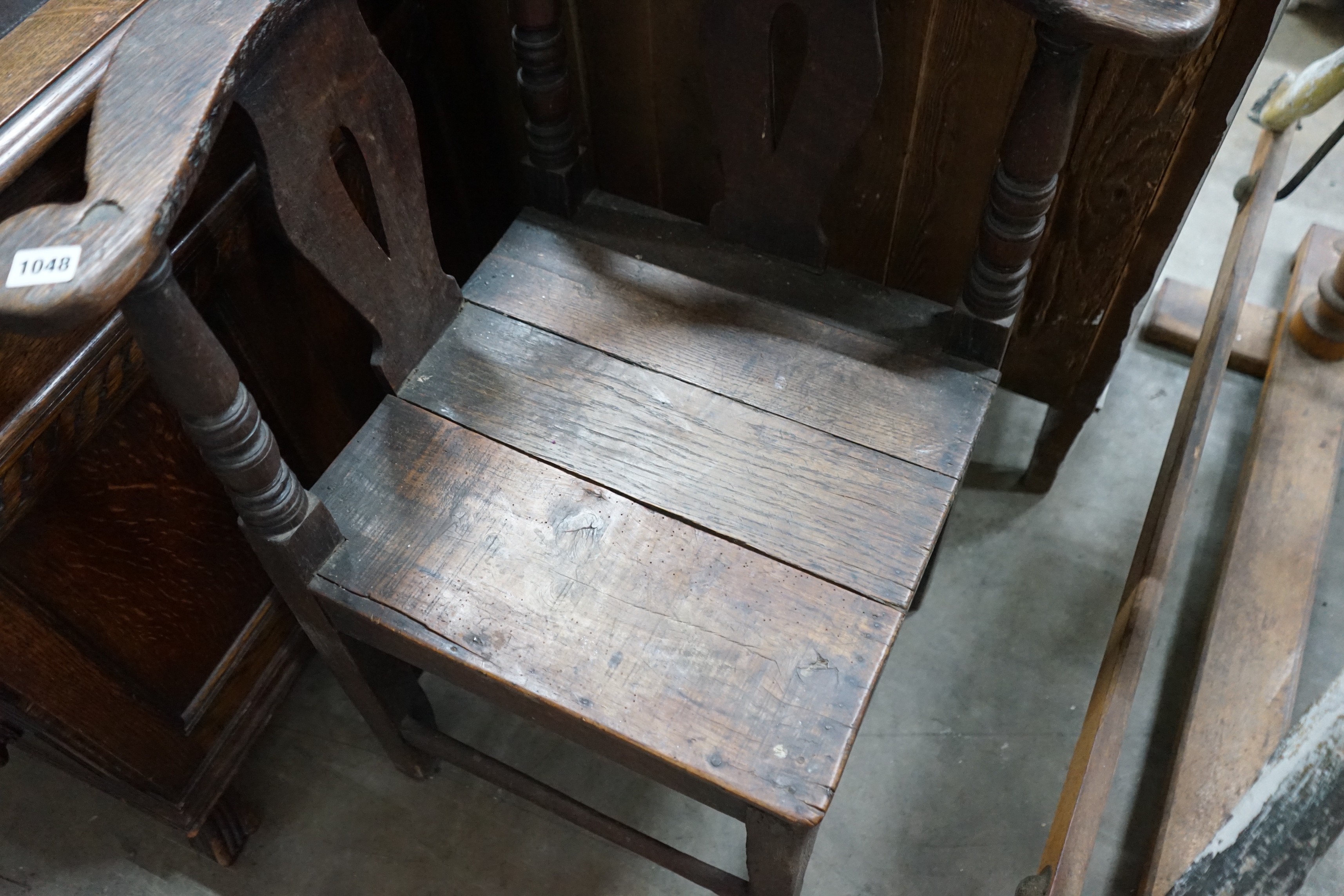 A mid 18th century oak corner elbow chair